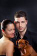 Couple in love with brown little pet puppy dog