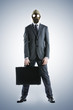 portrait of businessman in a gas mask  with suitcase