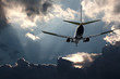 Passenger jet landing against a stormy sky
