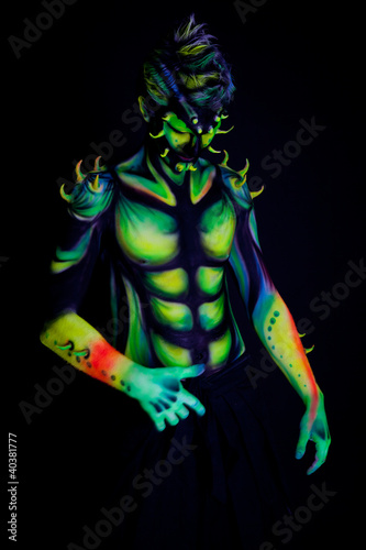 Photo: Man with fluorescent bodyart. Black background Man with fluorescent bodyart. Black background