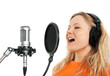 Photo: Girl in headphones singing with studio microphone Girl in headphones singing with studio microphone