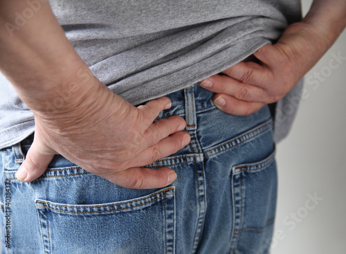 Photo: a man experiences pain in his hips a man experiences pain in his hips