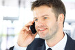 Smiling man using an office phone Smiling man using an office phone