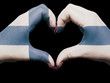 Heart and love gesture by hands colored in finland flag for tour