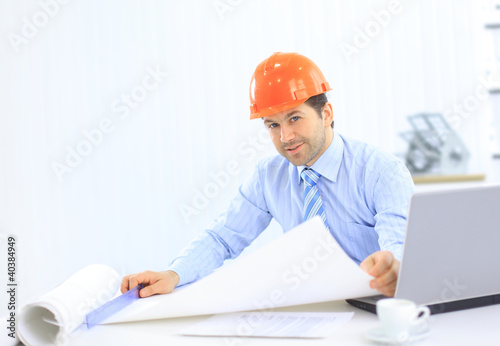 Photo: Engineer working at his laptop in the office Engineer working at his laptop in the office