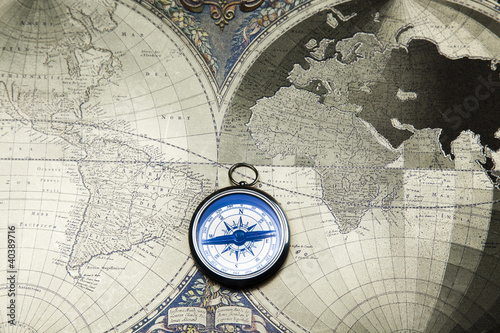 Photo: Compass on the old map background Compass on the old map background