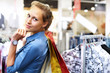 Woman in a shop buying clothes