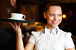 Portrait of young waitress holding a tray