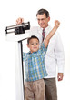 Doctor Weighing Cheering Little Boy on Weight Scale