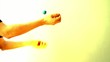 Man juggling Easter eggs against  colorful background