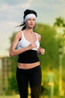 Woman running in green park