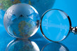 Magnifying glass and globe