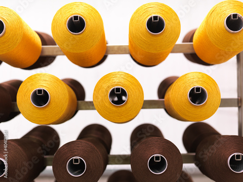 Photo: brown and yellow thread reels brown and yellow thread reels