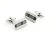 Pair of silver cuff links over white