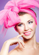 Beautiful smiling girl with pink makeup and bow