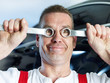 Photo: Ridiculous motor mechanic in a garage has a lot of fun at work Ridiculous motor mechanic in a garage has a lot of fun at work