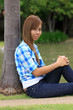 asian women wearing a blue plaid shirts and dark blue jeans