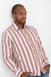Confident Afro-American guy posing at wall