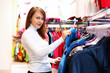 Young woman inside a store buying clothes
