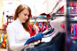 Young woman inside a store buying clothes