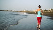 Young woman jogging on the beach, slow motion