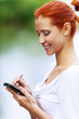 woman writes stylus on screen of device