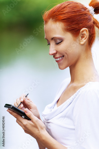 Photo: woman writes stylus on screen of device woman writes stylus on screen of device