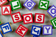 Wooden blocks forming the letters SOS in the center Wooden blocks forming the letters SOS in the center