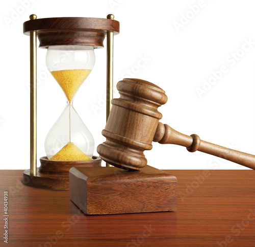 Photo: Hourglass and gavel isolated on white Hourglass and gavel isolated on white
