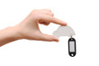 woman hand holding model car with blank tag isolated on white ba