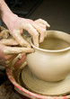 hands of a potter, creating an earthen jar of white clay hands of a potter, creating an earthen jar of white clay