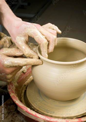 Photo: hands of a potter, creating an earthen jar of white clay hands of a potter, creating an earthen jar of white clay