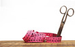 Old scissors and measuring tape on wooden background Old scissors and measuring tape on wooden background