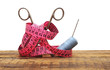 tools for needlework grey thread and scissors on wooden backgrou