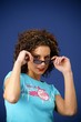 woman with curly hair wearing sunglasses