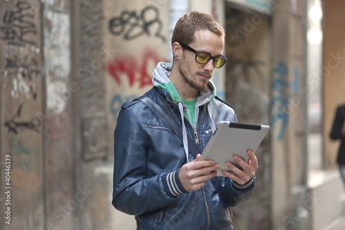 Photo: Man On Street Use Ipad Tablet Computer Man On Street Use Ipad Tablet Computer