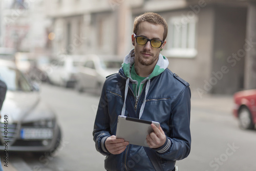 Photo: Man On Street Use Ipad Tablet Computer Man On Street Use Ipad Tablet Computer