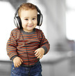 portrait of a handsome kid listening to music and smiling indoor portrait of a handsome kid listening to music and smiling indoor