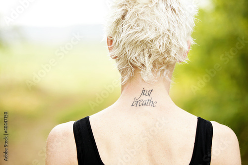 Photo: Female runner with tattoo on her neck Female runner with tattoo on her neck