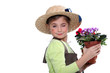 Little girl wearing straw hat holding plant pot Little girl wearing straw hat holding plant pot