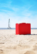 Red Travel Vacation Suitcase on Beach Red Travel Vacation Suitcase on Beach