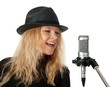 Photo: Singer in black hat singing with the microphone Singer in black hat singing with the microphone