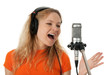 Photo: Singer in headphones singing with the microphone Singer in headphones singing with the microphone