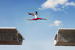 Attractive woman jumping with laptop