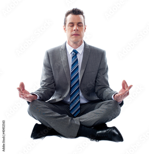 Photo: Businessman meditating in lotus position Businessman meditating in lotus position