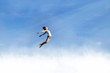 Freedom: Woman jumping over the clouds