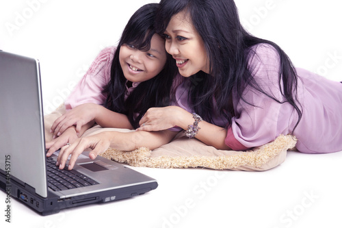 Photo: Happy asian family on a laptop Happy asian family on a laptop