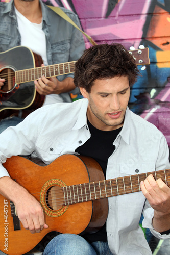 Photo: Young man playing guitar Young man playing guitar