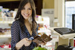 Cute woman paying at the cash register