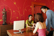A couple choosing a spa package at the reception counter of thai resort spa.